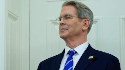 Treasury Secretary Scott Bessent listens as President Donald Trump speaks with reporters as he participates in a ceremonial swearing in of Paul Atkins as chairman of the Securities and Exchange Commission, in the Oval Office of the White House, Tuesday, April 22, 2025, in Washington.
