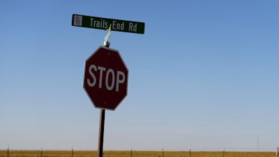 A sign for Trails End Road, home to the JBS meat processing plant, rests on a stop sign, Tuesday, April 15, 2025, in Dumas, Texas.