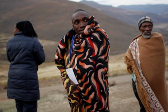 A Lesotho election official makes a phone call as he waits for last minute voters near the eastern Lesotho town of Mokhotlong Saturday May 26, 2012.