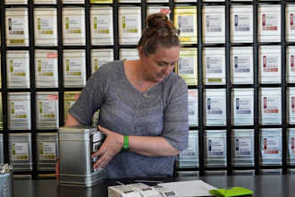 Owner Lisa McDonald packages a loose leaf tea orders at the TeaHaus, April 24, 2025, Ann Arbor, Mich.