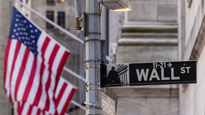 Wall Street sign is seen outside the New York Stock Exchange, Thursday, March. 21, 2024. Reddit shares will begin trading Thursday.