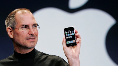Apple CEO Steve Jobs holds up an Apple iPhone at the MacWorld Conference in San Francisco, in this Jan. 9, 2007 file photo.