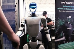 A Unitree robot shakes hands with a convention guest at the Robotics Summit & Expo, Wednesday, April 30, 2025, in Boston.