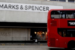 A bus passes a branch of Marks and Spencer in London, Tuesday, Aug. 18, 2020.