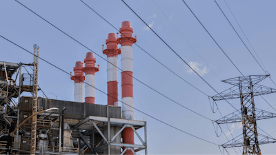 Power lines rise in front of electric towers and smokestacks at the Palo Seco power plant in Toa Baja, Puerto Rico, Thursday, May 8, 2025.