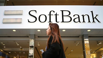 A woman walks in front of SoftBank store in Ginza shopping district in Tokyo, Jan. 20, 2020.