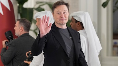 Elon Musk gestures as he arrives for a state dinner hosted by Qatar's Emir Sheikh Tamim bin Hamad Al Thani in honor of President Donald Trump at Lusail Palace in Doha, Qatar, Wednesday, May 14, 2025.