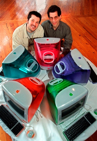 This March 19, 1999 file photo shows Jonathan Ive, left, Apple Computer's vice president of design, and Jon Rubinstein, Apple's senior vice president of engineering, posing behind five iMac personal computers at Apple headquarters in Cupertino, Calif.