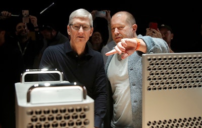 In this Monday, June 3, 2019 file photo, Apple CEO Tim Cook, left, and chief design officer Jonathan Ive look at the Mac Pro in the display room at the Apple Worldwide Developers Conference in San Jose, Calif.