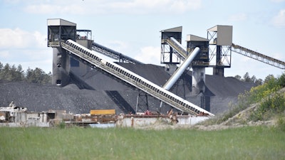A pile of coal, conveyor belts and towers for moving and storing coal are seen at Signal Peak Energy's Bull Mountains Mine, on May 21, 2025, near Roundup, Montana.