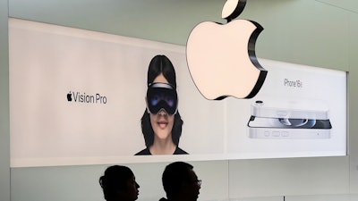 People visit an Apple Store, inside a shopping mall, in Beijing, Thursday, April 10, 2025.
