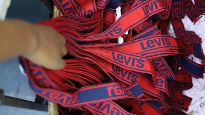 A label reading 'Levis' on a pair of Levi Strauss & Co jeans is displayed at a production line at United Aryan EPZ Limited in Ruaraka on the outskirts of Nairobi, Kenya, March. 21, 2025.