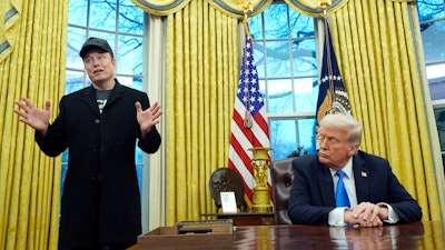 President Donald Trump listens as Elon Musk speaks in the Oval Office at the White House, Feb. 11, 2025, in Washington.