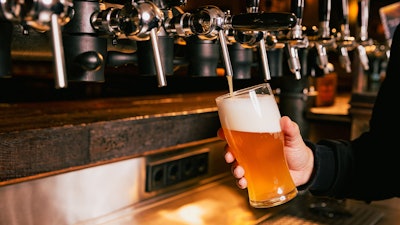 A bartender pouring a beer.