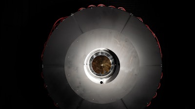 In the optical power beaming receiver designed for PRAD, the laser enters the center aperture, strikes a parabolic mirror, and reflects onto dozens of photovoltaic cells arranged around the inside of the device which convert the energy back to usable power.