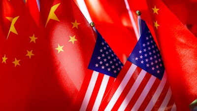 American flags are displayed together with Chinese flags on top of a trishaw on Sept. 16, 2018, in Beijing.