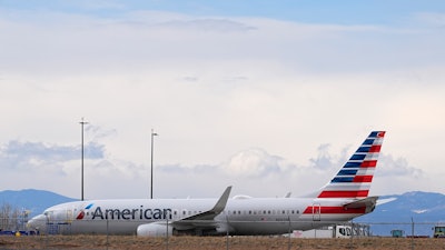 An American Airlines jetliner that caught fire after landing the previous day at Denver International Airport sits near a hangar at the airport, March 14, 2025, in Denver.