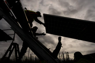 Workers install panels at a solar project Wednesday, May 21, 2025, in Galena, Alaska.
