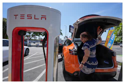 Janelle Lowe prepares to charge her electric vehicle at a charging station Thursday, May 22, 2025, in Long Beach, Calif.