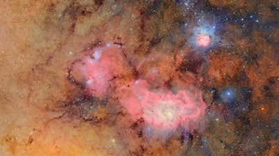 This image provided by the NSF-DOE Vera C. Rubin Observatory shows 678 separate images taken by the observatory in just over seven hours of observing time. Combining many images in this way clearly reveals otherwise faint or invisible details, such as the clouds of gas and dust that comprise the Trifid nebula (top right) and the Lagoon nebula, which are several thousand light-years away from Earth.