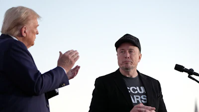 Republican presidential nominee former President Donald Trump, left, claps as Tesla and SpaceX CEO Elon Musk prepares to depart after a campaign event at the Butler Farm Show on Oct. 5, 2024, in Butler, Pa.