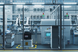 High-tech automated manufacturing facility with robotic arms and control systems.