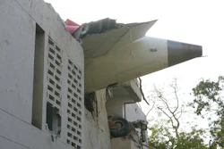 The debris of an airplane sticks out of a building after it crashed in India's northwestern city of Ahmedabad in Gujarat state, Thursday, June 12, 2025.