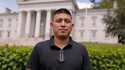 Dairy farmworker José Molina-Aguilar stands outside the Vermont Statehouse after a rally for housing rights for migrant farmworkers in Montpelier, Vt., June 13, 2025.