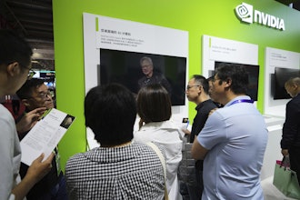 An exhibitor introduces the Nvidia DGX Spark to visitors at the Nvidia exhibition booth during the 3rd China International Supply Chain Expo at the China International Exhibition Center, in Beijing, Thursday, July 17, 2025.