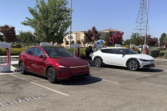 This photo provided by Edmunds shows a Tesla Model Y and a Kia EV6 parked at a Tesla Supercharger station in Fresno, Calif. Planning a cross-country trip in an EV takes extra effort, but doing it properly can make the journey almost as smooth as in a gas-powered vehicle.