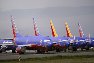 A line of Southwest Air Boeing 737 jets are parked near the company's production plant while being stored at Paine Field Friday, April 23, 2021, in Everett, Wash.