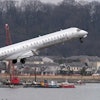 Salvage crews work on recovering wreckage near the site in the Potomac River of a mid-air collision between an American Airlines jet and a Black Hawk helicopter at Ronald Reagan Washington National Airport, Thursday, Feb. 6, 2025, in Arlington, Va.