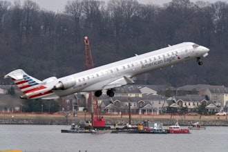 Salvage crews work on recovering wreckage near the site in the Potomac River of a mid-air collision between an American Airlines jet and a Black Hawk helicopter at Ronald Reagan Washington National Airport, Thursday, Feb. 6, 2025, in Arlington, Va.