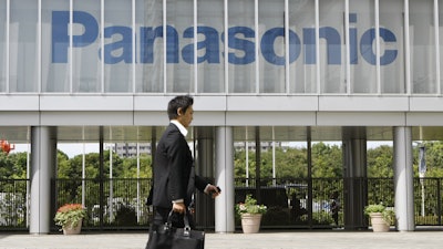A businessman walks past a corporate logo of Japanese electronics maker Panasonic Corp. at Panasonic Center in Tokyo, Japan, Sept. 10, 2009.