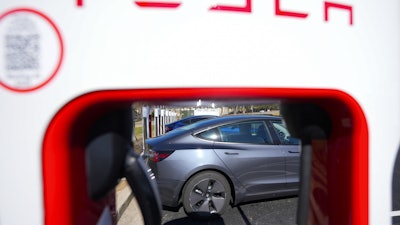 A Tesla level three Electric vehicle charger is visible, Feb. 2, 2024, in Kennesaw, Ga., near Atlanta.
