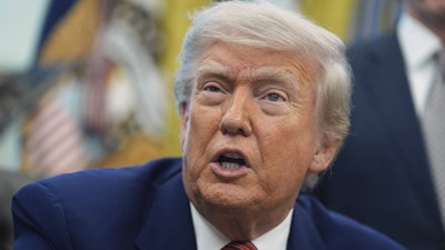 President Donald Trump speaks to reporters in the Oval Office of the White House, May 23, 2025, in Washington.