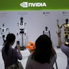 Visitors give commands to a robot at Nvidia's booth during the 3rd China International Supply Chain Expo at the China International Exhibition Center, in Beijing, China, Friday, July 18, 2025.