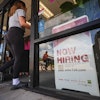 A 'now hiring' sign, July 15, 2025, Richardson, Texas.