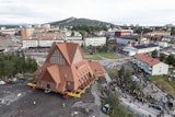 On a specially designed trolley with 224 wheels, Kiruna Church is moved for relocation at a speed of half a kilometer per hour, in Kiruna, Sweden, Tuesday Aug. 19, 2025.