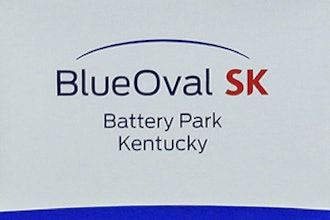 Logos for BlueOval SK and Ford are displayed on a podium during a celebration for the progress of the BlueOval SK Battery Park in Glendale, Ky., Dec. 5, 2022.