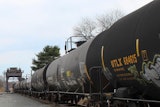 This image provided by the Howard Center for Investigative Journalism shows a train carrying tank cars, some containing hazardous materials, traveling across a railroad bridge in Paulsboro, N.J., on March 20, 2025, that was the site of a derailment and spill of toxic vinyl chloride in 2012.