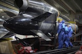 Workers inspect a Flamingo cruise missile at Fire Point's secret factory in Ukraine on Monday, Aug. 18, 2025.