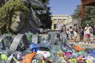 Plastic items are seen next to an artwork by Canadian artist and activist Benjamin Von Wong, titled 'The Thinker's Burden', a 6-meter-tall sculptural remix of Rodin's iconic Thinker, created especially for the Plastics Treaty negotiations, on Place des Nations in front of the European headquarters of the United Nations in Geneva, Switzerland, Monday, Aug. 4, 2025 before the second segment of the fifth session of the Intergovernmental Negotiating Committee on Plastic Pollution (INC-5.2).