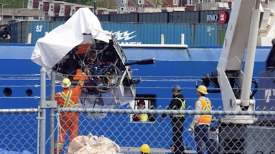 Debris from the Titan submersible, recovered from the ocean floor near the wreck of the Titanic, is unloaded from the ship Horizon Arctic at the Canadian Coast Guard pier in St. John's, Newfoundland, Wednesday, June 28, 2023.