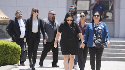 Gloria Cazares, right, holds hands with Veronica Mata during a break in a court hearing in a lawsuit between victims' families in the 2022 Uvalde, Texas school shooting and Meta Platforms on Friday, July 18, 2025, in Los Angeles.