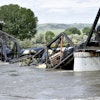 Train cars are immersed in the Yellowstone River after a bridge collapse near Columbus, Mont., June 24, 2023.