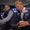 Trader Robert Charmak, right, and specialist Glenn Carell, center, work on the floor of the New York Stock Exchange, Sept. 10, 2025.