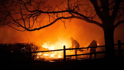 Residents fight the Marshall Fire in Louisville, Colo., Dec. 30, 2021.