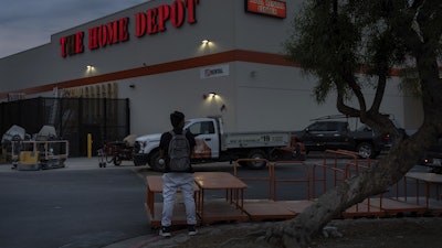 A day laborer waits for work in the parking lot of a Home Depot in the Van Nuys section of Los Angeles, TAug. 28, 2025.