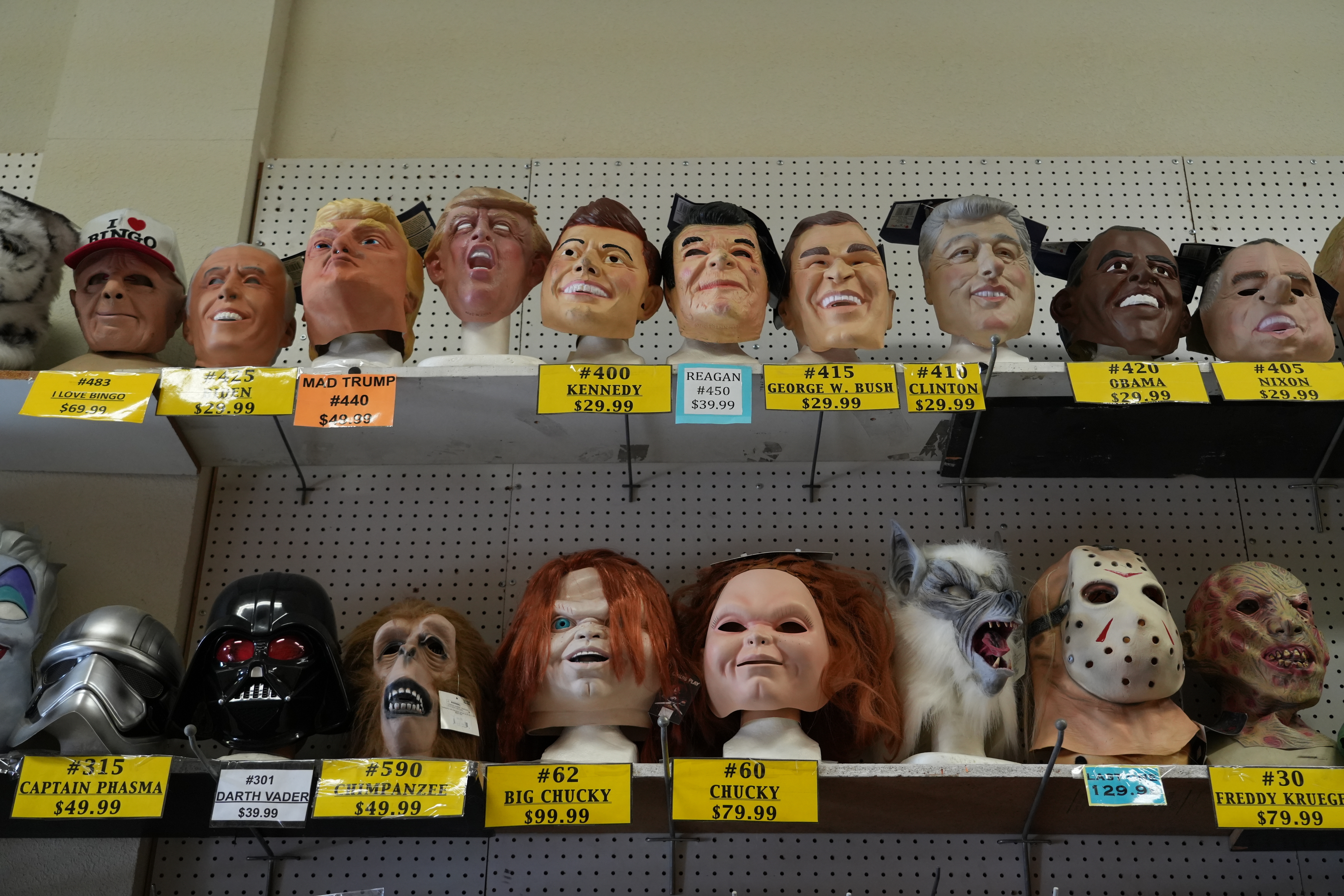 A variety of face masks line the shelves at the House of Humor costume shop in Redwood City, Calif., Thursday, Sept. 18, 2025.